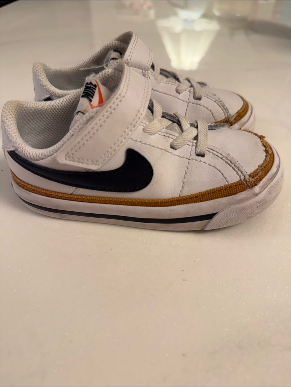 Nike White Kids Sneakers with Black Swoosh and Brown Accent